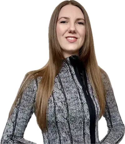 Woman with long hair, wearing a sweater, posing with crossed arms, representing the Bite of Code community.